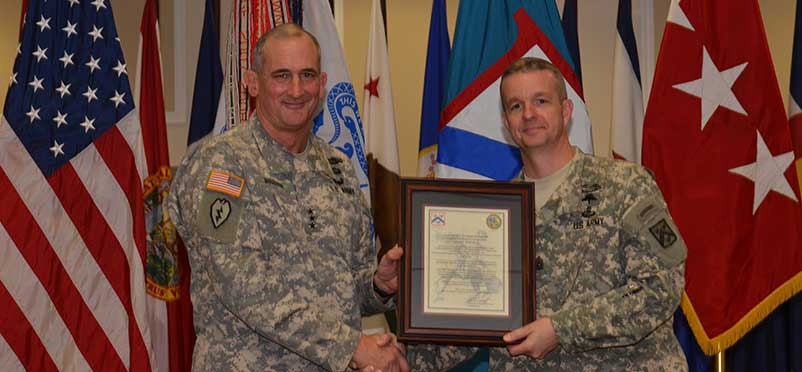 CSM Turnbull posing with Lt. Gen. Brown and the assumption of responsibility certificate