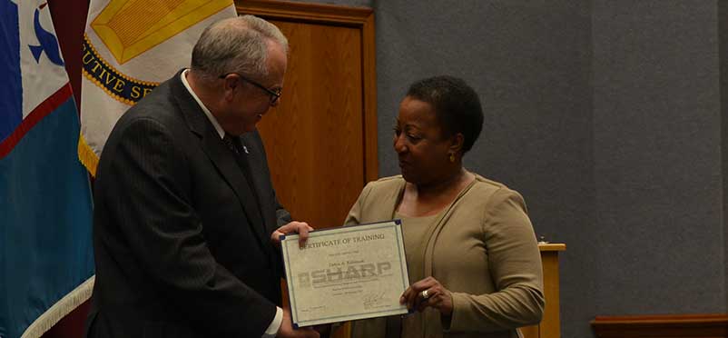 Kirby Brown presenting Debra A. Robinson with her certificate